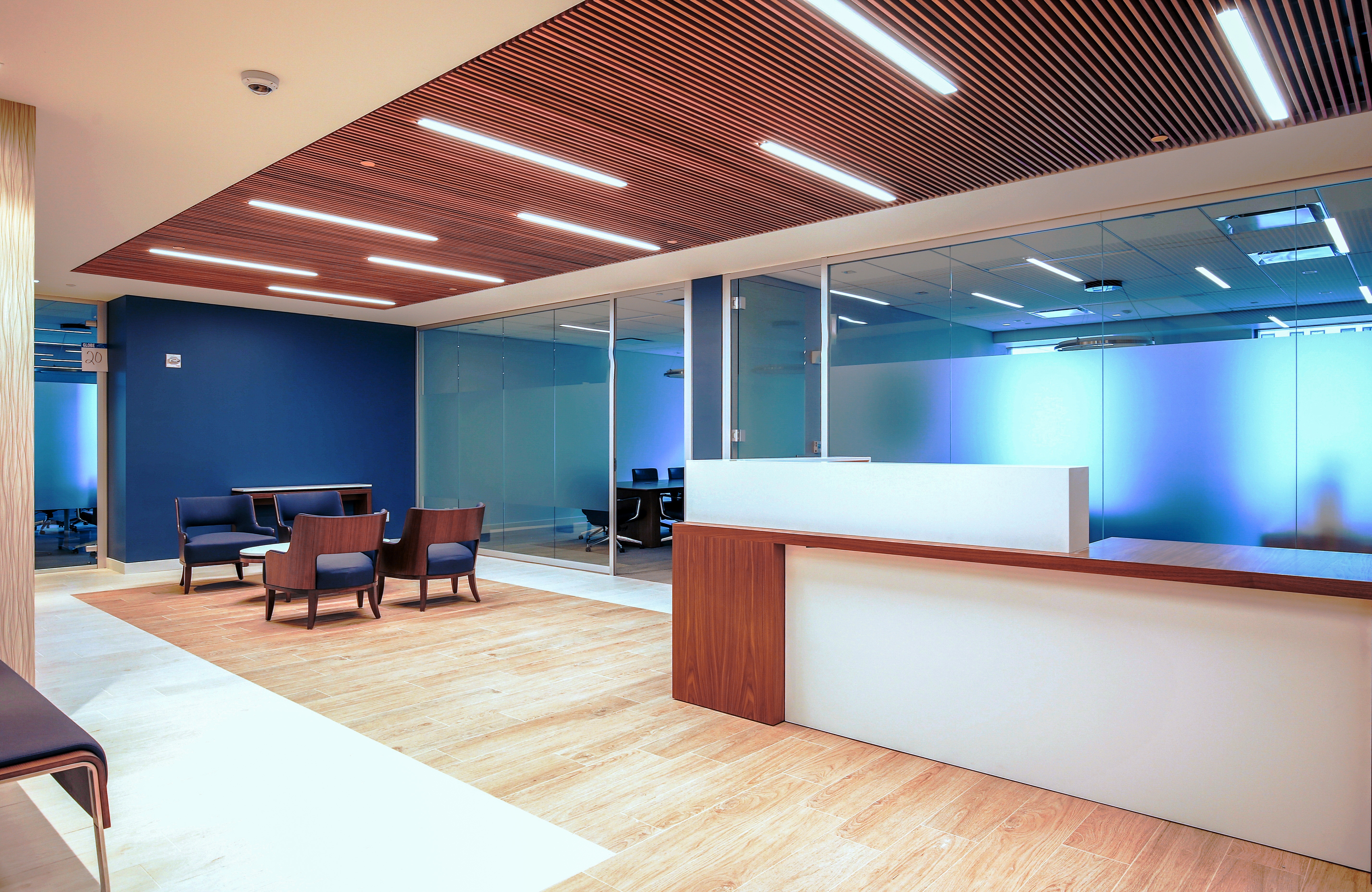New York Law Firm office reception area with acoustic ceiling panels and frosted glass office walls